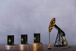 Oil tanks stacked on top of quarters next to an oil drilling machine.