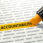 The word accountability highlighted with marker on a paper listing other related words.