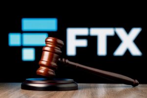 A gavel in front of the logo for FTX.