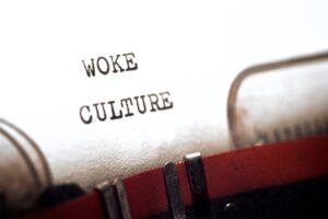 The phrase “woke culture” written on a typewriter.