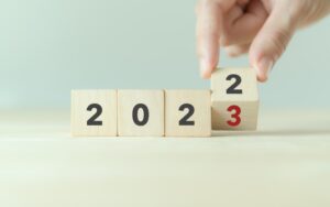 Four blocks that read “2022” with the last block on the right being turned to a 3.