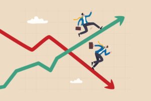 A man standing on top of a green line trending upward and a red line trending downward.