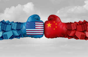 Two boxing gloves - one red and one blue - depicting the U.S. and China hitting each other.