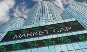 The words “MARKET CAP” on a digital board in front of a building on Wall Street.