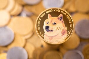 A golden Dogecoin in front of a pile of other gold coins.