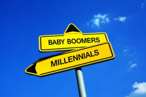 A crossroads with two signs that read “BABY BOOMERS” and “MILLENNIALS.”