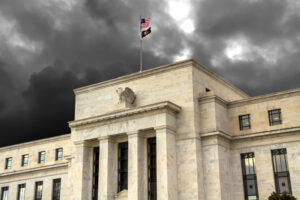 The Federal Reserve building in Washington, D.C., with dark clouds in the background.