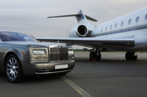 A private jet and car on a runway.