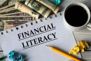 A paper that reads “FINANCIAL LITERACY” with money behind it.