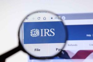A magnifying glass showing the word “IRS” on a website.