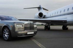 A close-up shot of an expensive car and private jet.