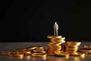 A figurine of a man standing on top of gold coins.