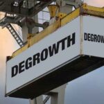 A shipping container with the word “DEGROWTH” on it.
