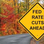 A sign on a road that says, “FED RATE CUTS AHEAD.”