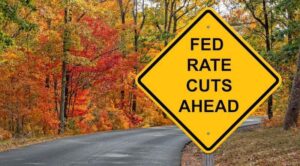 A sign on a road that says, “FED RATE CUTS AHEAD.”