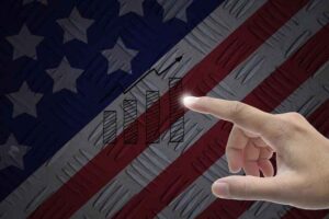 A person pointing at the American flag.