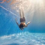 boy diving into pool