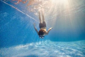 boy diving into pool